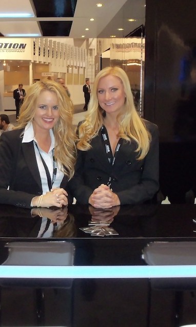 Two professionally dressed exhibit booth models